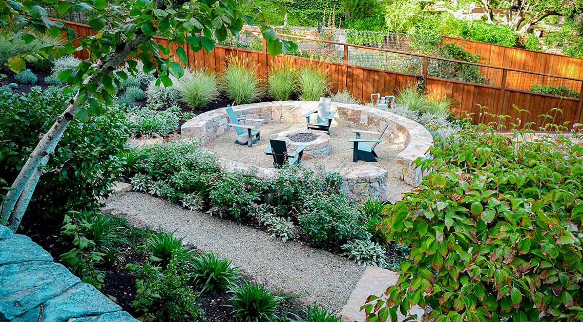 Terraced back yard with outdoor seating and firepit
